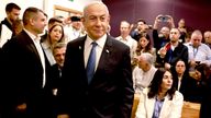 Israeli Prime Minister Benjamin Netanyahu smiles as he prepares to testify.
Pic: Reuters