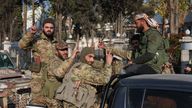 Rebel fighters gestures in Damascus, Syria.
Pic: Reuters