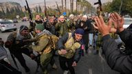 Opposition fighters celebrate in Damascus, Syria, Sunday Dec. 8, 2024. (AP Photo/Hussein Malla)