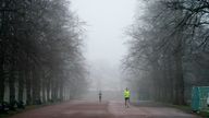 A jogger in foggy weather in Greenwich Park.
Pic: PA