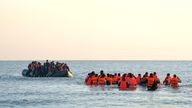 A group thought to be migrants wade through the sea to board a small boat off the beach in Gravelines, France.
File pic: PA