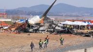 Firefighters and rescue teams work in the aftermath of the crash.
Pic: AP/Ahn Young-joon