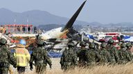 South Korean soldiers work near the wreckage.
Pic: AP