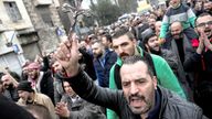 A man carries a cross at a protest against the burning of the Christmas tree in Hama, at Bab Touma neighbourhood in Damascus, Syria.
Pic: Reuters
