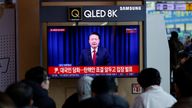 People watch the live broadcasting of South Korean President Yoon Suk Yeol.
Pic: Reuters