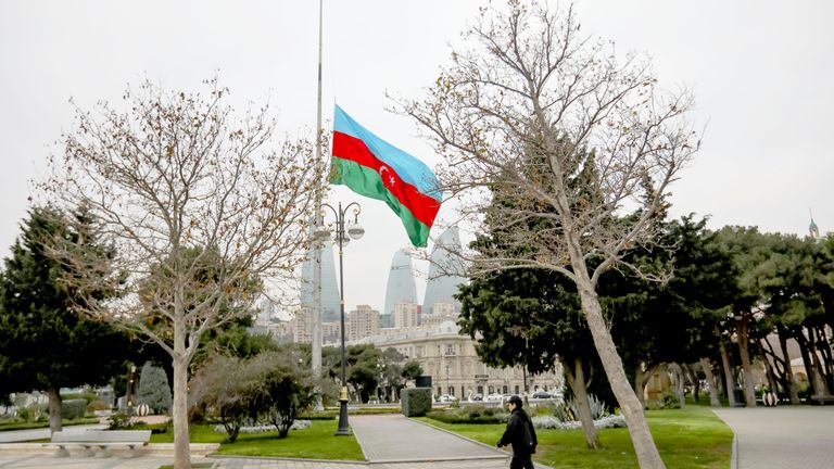 Azerbaijan's national flag at half-mast in the memory of victims of the Azerbaijan Airlines' Embraer 190 that crashed near the Kazakhstan's airport of Aktau, is seen in the center of Baku, Azerbaijan, Thursday, Dec. 26, 2024. (AP Photo/Aziz Karimov)