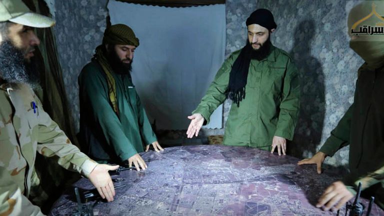 FILE - This undated photo released by a militant group in 2016, shows Abu Mohammed al-Golani, the leader of Syria's al-Qaida affiliate, second from right, discussing battlefield details with commanders in Aleppo, Syria. (Militant UGC via AP, File)