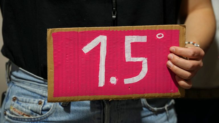 An activist holds a sign that reads 1.5 during a demonstration at the COP29 U.N. Climate Summit, Friday, Nov. 22, 2024, in Baku, Azerbaijan. (AP Photo/Peter Dejong)