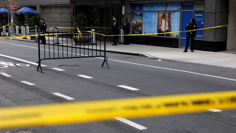 Police officers stand near the scene where the CEO of United Healthcare Brian Thompson was reportedly shot and killed in Midtown Manhattan.
Pic: Reuters