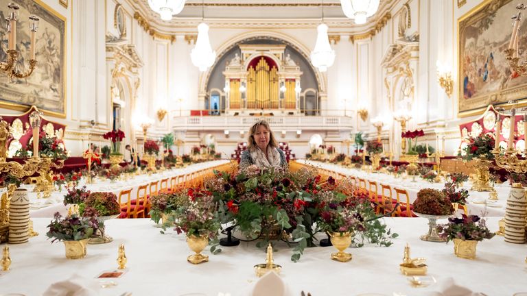 Finishing touches are applied to seasonal flowers on the tables in the ballroom of Buckingham Palace. Pic: Reuters