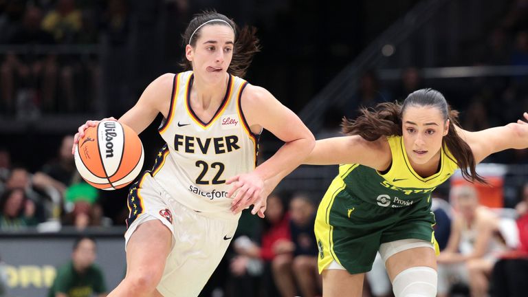 FILE - Indiana Fever guard Caitlin Clark (22) drives as Seattle Storm guard Nika Muhl defends during the second half of a WNBA basketball game, Wednesday, May 22, 2024, in Seattle. (AP Photo/Jason Redmond, File)