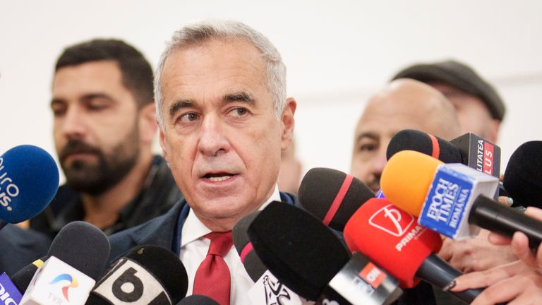 Calin Georgescu, an independent candidate for president who came first after the first round of presidential election, speaks to media after casting his vote in the country's parliamentary election in Mogosoaia, Romania, Sunday, Dec. 1, 2024. (AP Photo/Vadim Ghirda)