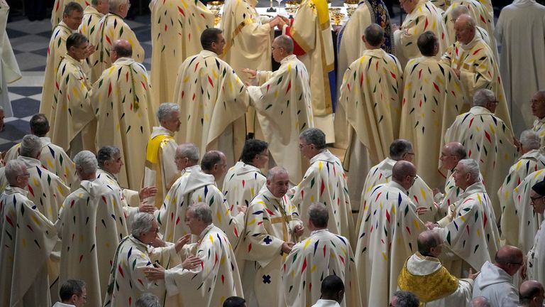 Clergy members attend the inaugural mass at Notre Dame Cathedral, hosting its first Mass since the catastrophic fire of 2019,, Sunday, Dec. 8, 2024 in Paris. (AP Photo/Alessandra Tarantino, Pool)