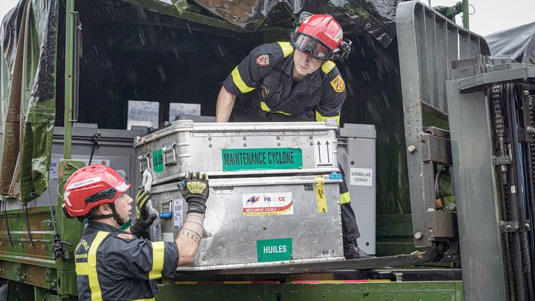 Rescue workers transport a container in storm-hit Mayotte,
Pic: UIISC7/Securite Civile/Reuters 