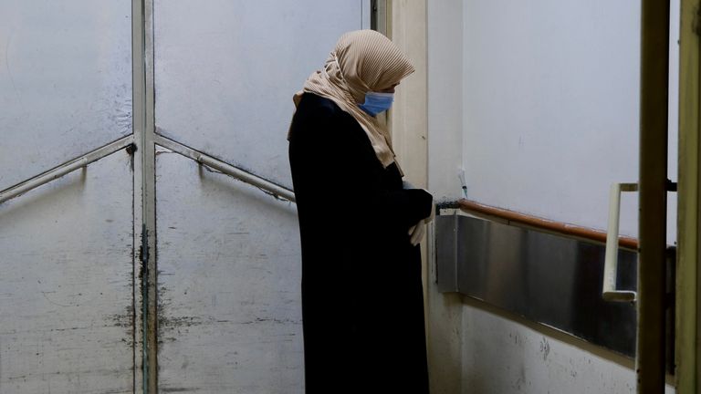 A woman waits outside an examination room in Damascus, Syria.