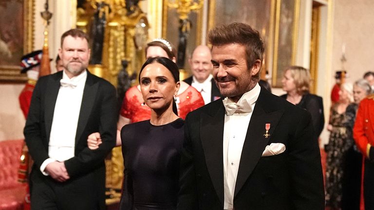 David and Victoria Beckham walk to the Buckingham Palace ballroom. Pic: Reuters