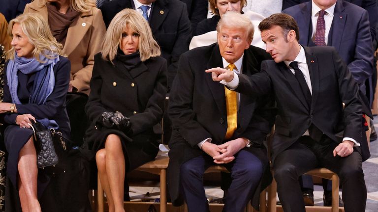 Donald Trump sat next to French President Emmanuel Macron at the service. Pic: Reuters