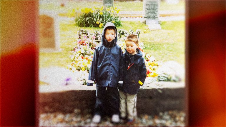 Andrew and his brother at their father's grave