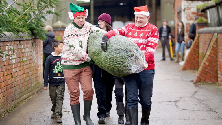 Ed Davey and Tewkesbury MP Cameron Thomas carry a Christmas tree during a visit to Pamington Farm Christmas Tree Centre near Tewkesbury.
Pic: PA