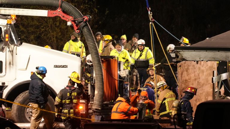 Rescue workers search in a sinkhole for Elizabeth Pollard, who disappeared while looking for her cat, in Marguerite, Pa., Tuesday, Dec. 3, 2024. (AP Photo/Gene J. Puskar)