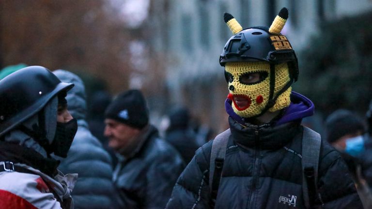 Protesters gather in a street during a rally to demand new parliamentary elections in the country, near the Parliament's building in Tbilisi, Georgia, on Monday, Nov. 25, 2024. (AP Photo/Zurab Tsertsvadze)