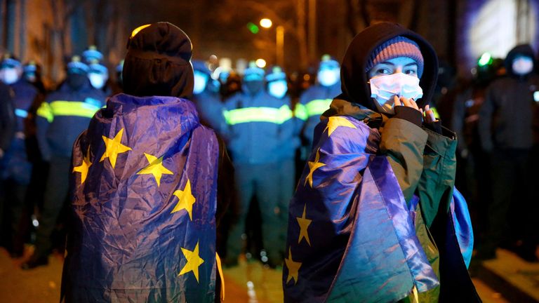 People wrapped in the European Union flags attend a rally held by supporters of Georgia's opposition parties to protest against the government's decision to suspend talks on joining the European Union in Tbilisi, Georgia December 4, 2024. REUTERS/Irakli Gedenidze