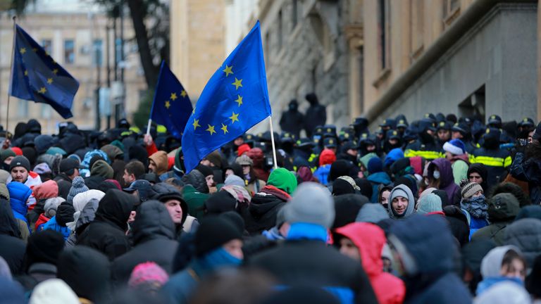 Demonstrators with EU flags rally outside the parliament to protest against the government's decision to suspend negotiations on joining the European Union in Tbilisi, Georgia, Saturday, Dec. 14, 2024. (AP Photo/Zurab Tsertsvadze)