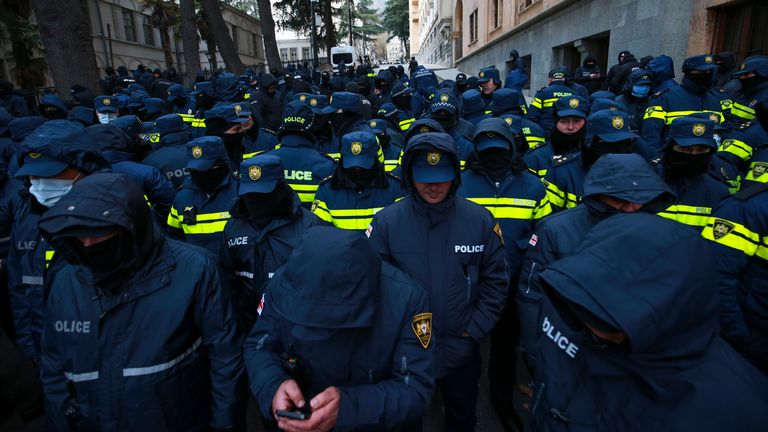 Police block a street to prevent demonstrators during a rally outside the Georgian parliament.
Pic: AP