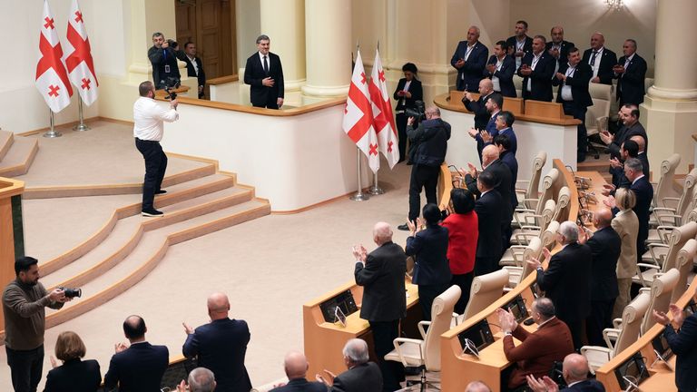 Georgian president-elect Mikheil Kavelashvili is greeted by the electoral college members at the Georgian parliament, in Tbilisi.
Pic: AP