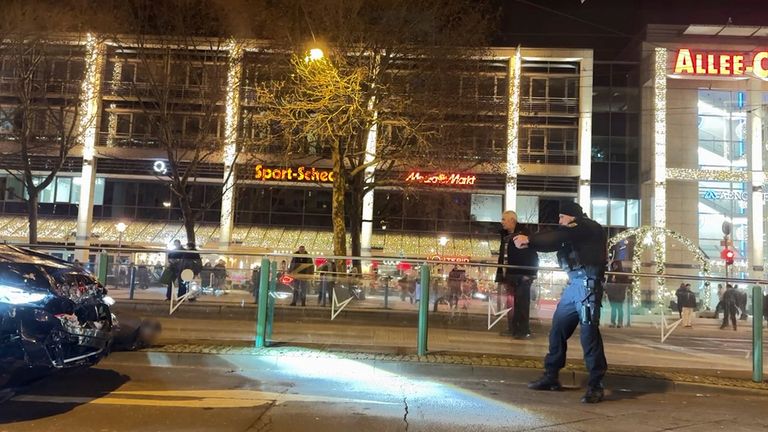 Police officers arrest a suspect at the Christmas market. Pic: Privat/picture-alliance/dpa/AP Images