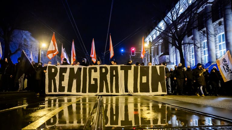 "Remigration" is written on a banner at a demonstration by right-wing groups in Magdeburg, Germany, on Saturday, Dec. 21, 2024, a day after a driver drove into a group of people at the Christmas market in the city. (dpa via AP)


