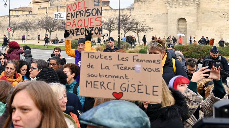 People hold placards as they gather in support of Frenchwoman Gisele Pelicot, the victim of an alleged mass rape orchestrated by her then-husband Dominique Pelicot at their home in the southern French town of Mazan, during the verdict in the trial for Dominique Pelicot and 50 co-accused, in front of the courthouse in Avignon, France, December 19, 2024. The slogans read "Christmas in prison, Easter in prison" and "All the women on earth support you, thank you Gisele". REUTERS/Alexandre Dimou