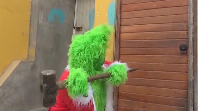 Officer dresses as Grinch for drugs raid in Peru | Offbeat News | Sky News