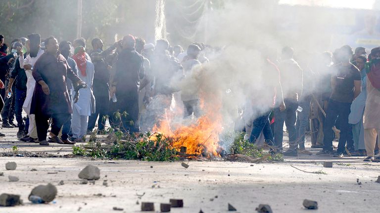 Supporters of Pakistan's former Prime Minister Imran Khan burn tires and other material as they block a road as a protest against the arrest of their leader, in Karachi, Pakistan, Tuesday, May 9, 2023.  Khan was arrested Tuesday as he appeared in a court in the country...s capital, Islamabad, to face charges in multiple graft cases. Security agents dragged Khan outside and shoved him into an armored car before whisking him away. (AP Photo/Fareed Khan)