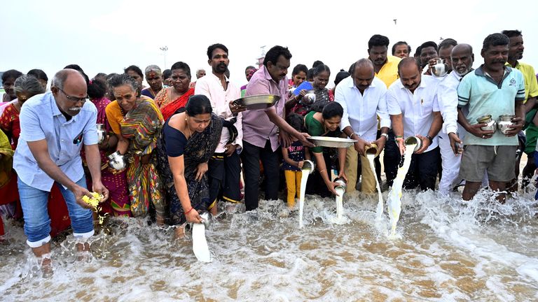 People pour milk into the Bay of Bengal as a gesture of respect to the victims of the 2004 Indian Ocean Tsunami on the 20th anniversary of the disaster, at Marina Beach in Chennai, India, December 26, 2024. REUTERS/Riya Mariyam R

