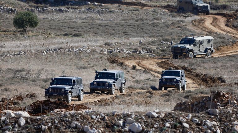 Israeli soldiers ride in military vehicles as they gather near the ceasefire line between Syria and the Israeli-occupied Golan Heights.
Pic: Reuters