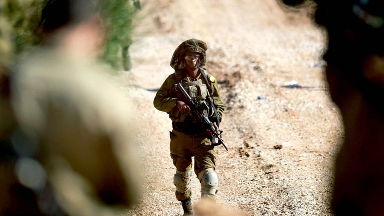 Israeli soldiers stand guard near the ceasefire line between Syria and the Israeli-occupied Golan Heights.
Pic: Reuters