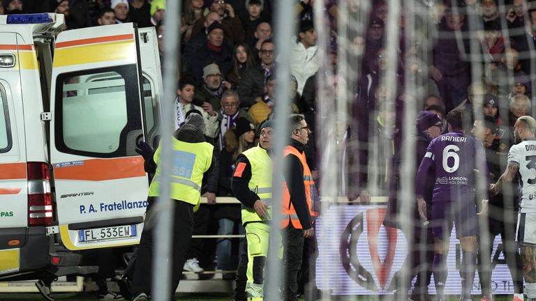 An ambulance enters the field as Fiorentina's Edoardo Bove, injured, is surrounded by players during the Serie A soccer match between Fiorentina and Inter at the Artemio Franchi Stadium in Florence, Italy, Sunday Dec. 1, 2024. The match was suspended and finally postponed as the injures appeared to be serious. (Massimo Paolone/LaPresse via AP)