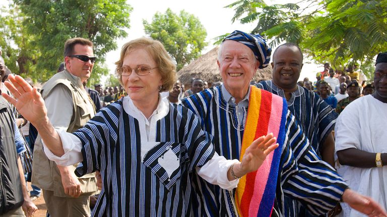 Former U.S. President Jimmy Carter and former First Lady Rosalynn Carter wear traditional Ghanaian attire, a gift from the chief of Tingoli village in northern Ghana, during a field trip to assess Carter Center disease prevention work in Africa in February 2007. Pic: The Carter Center