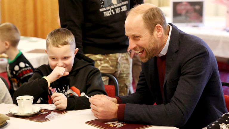 The Prince of Wales reacts as he looks at a portrait drawn by Karson Heighway.
Pic: PA