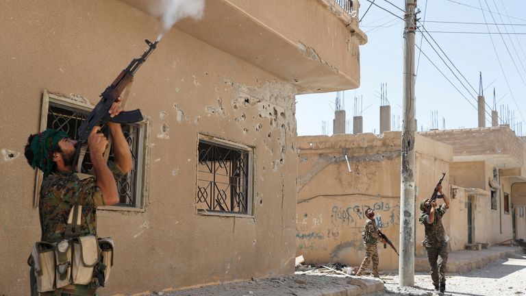 Kurdish fighters from the People's Protection Units (PYG) fire at Islamic State militants in Raqqa in 2017. Pic: Reuters