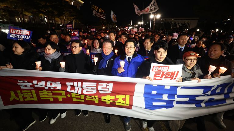 South Korea's main opposition Democratic Party leader Lee Jae-myung (4th left) marches with his party members during a rally against the President Yoon Suk Yeol at the National Assembly in Seoul, South Korea.
Pic: AP