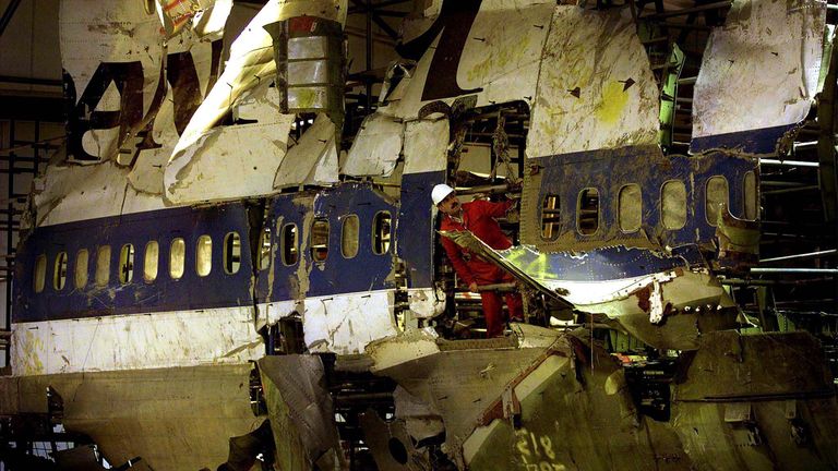 An engineer from the Air Crash Investigation Unit peers out in this December 8, 1988 file photo, from the reconstructed remains of the Pan Am Boeing 747 jumbo jet that crashed into the Scottish village of Lockerbie in December 8, 1988. Libya and lawyers for families of the 1988 Lockerbie bombing victims signed an agreement August 13, 2003 to create a bank account to hold $2.7 billion in compensation in a key step toward resolving the dispute, a lawyer said. The mid-air bombing killed 259 mostly 