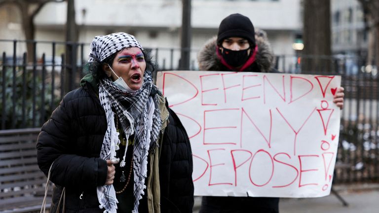 A person holds a placard outside New York Supreme Court, on the day of an arraignment hearing for Luigi Mangione, the suspect in the killing of UnitedHealth Group chief executive Brian Thompson, in New York City, U.S. December 23, 2024. REUTERS/Kent Edwards