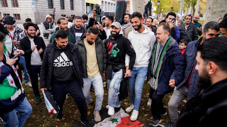 People step on the Syrian government flag during a protest celebrating the fall of Bashar al-Assad's regime in front of the Syrian embassy in Madrid, Spain, on December 8, 2024. Reuters/Ana Beltran