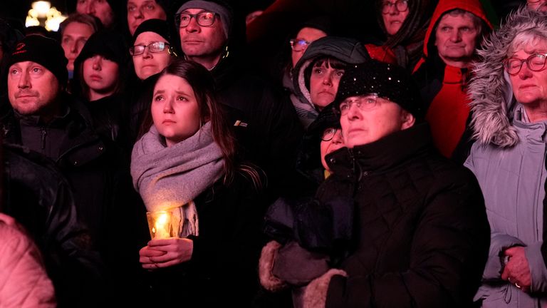 People outside Magdeburg Cathedral follow a memorial service for victims of Friday&#39;s Christmas Market attack, where a car drove into a crowd, in Magdeburg, Germany, Saturday, Dec. 21, 2024. (AP Photo/Ebrahim Noroozi)