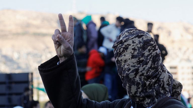 A man gestures the victory sign as he takes part in celebration. Pic: Reuters

