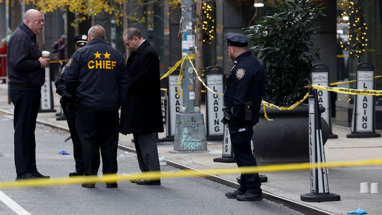 Police officers stand near the scene where the CEO of United Healthcare Brian Thompson was reportedly shot and killed in Midtown Manhattan.
Pic: Reuters