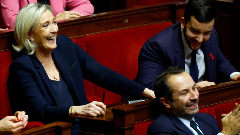 Marine Le Pen laughs during a debate on the no confidence vote. Pic: Reuters