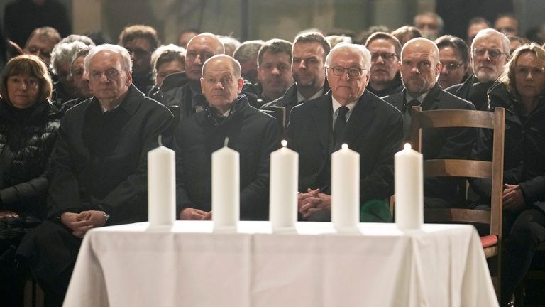 Chancellor Olaf Scholz (C) and German president Frank-Walter Steinmeier (R) at the memorial service. Pic: AP